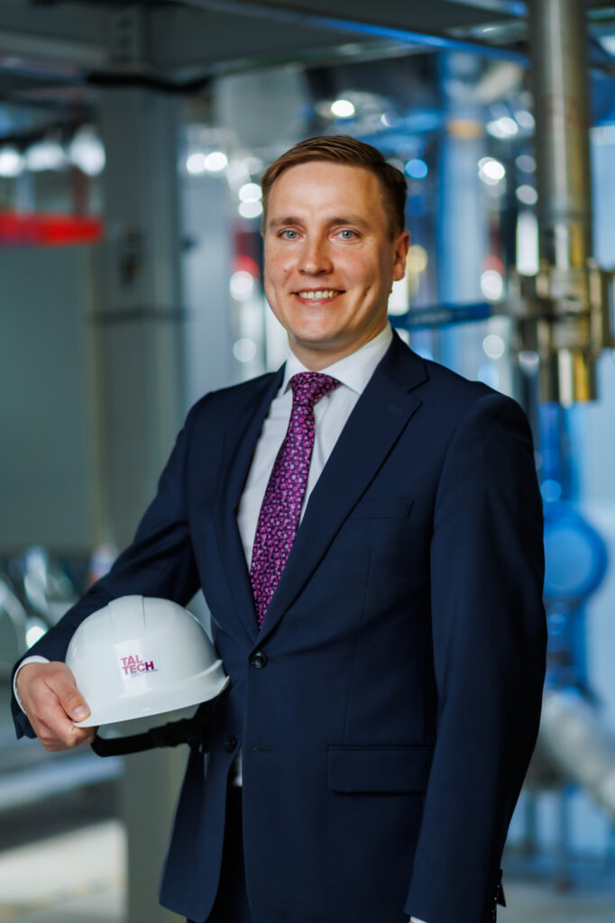 Professor Alar Konist wearing a suit and holding a safety helmet under his arm.